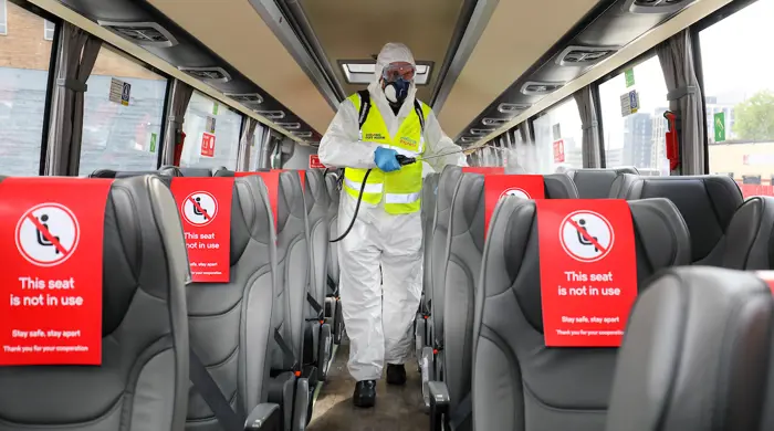Cleaner In PPE On Bus