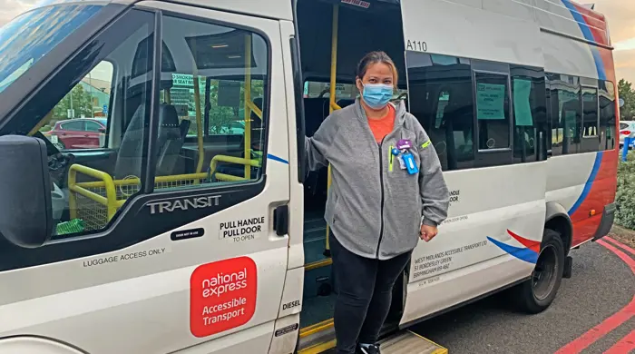 NHS Worker In Front Of NEAT Shuttle